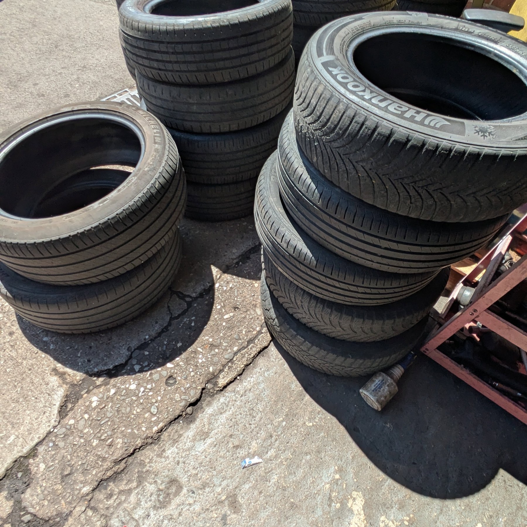 Stacks of tyres on the forecourt in the sun