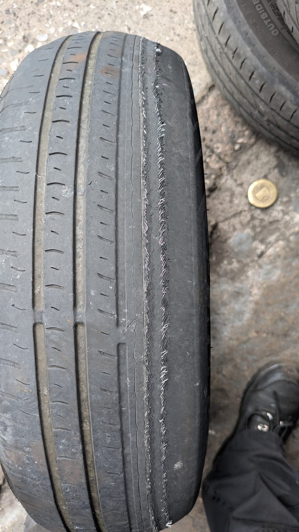 A tyre worn almost completely smooth across the tread