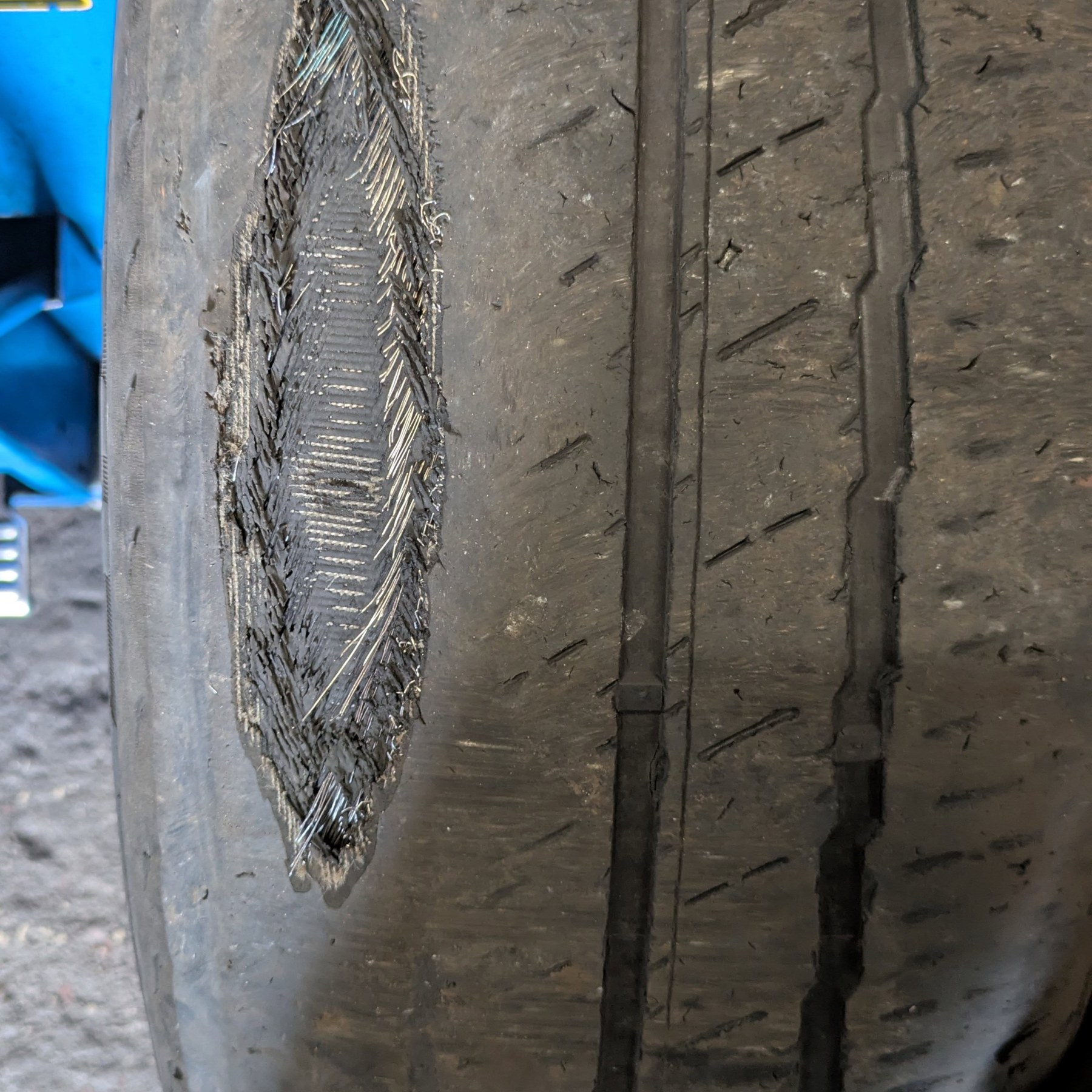 A tyre worn through until the cords show
