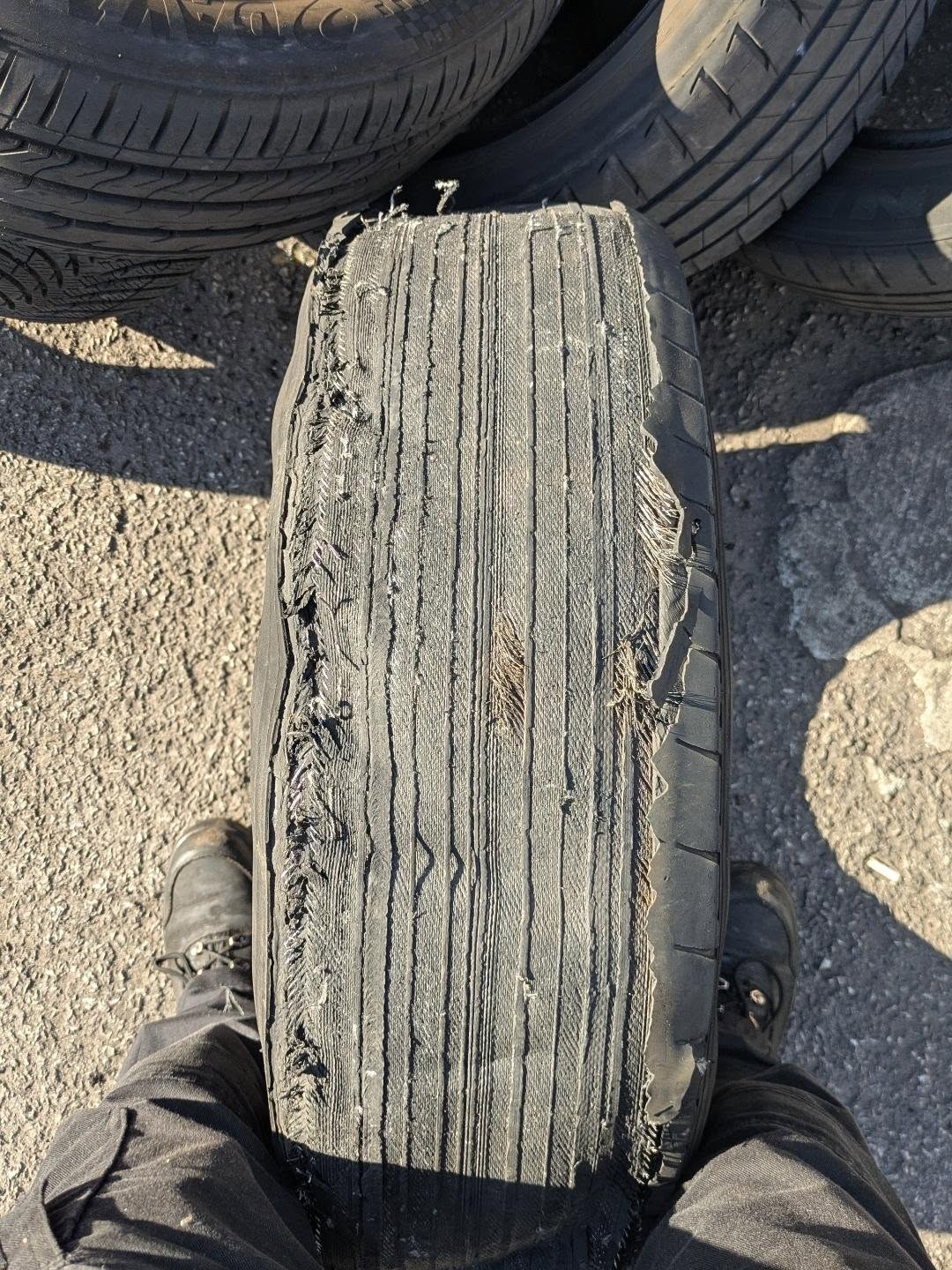 A tyre with both edges of the tread shredded